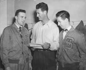 Suffolk University Seniors Dick Conway and Don Shea welcome Boston Red Sox star Ted Williams at a Suffolk Varsity Club event