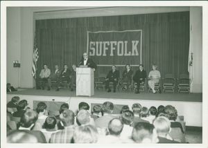 Guest speaker behind podium at an event in Suffolk University's C. Walsh Theatre (55 Temple Street)