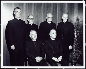 Group portrait of clergy. Fr. Michael Walsh seated on right.