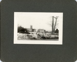 Gasson Hall, Saint Mary's Hall, and Devlin tower from road behind fence by Clifton Church