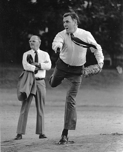 Mayor Raymond L. Flynn playing baseball with Parks Commissioner Patrick Harrington in background