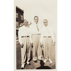 Laymon Hunter and two men stand on a street