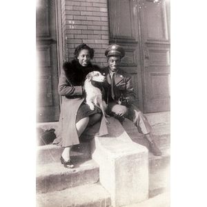 Viola and unidentified man pose with Frisky the dog
