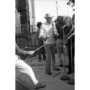Man in a Panama hat, playing maracas