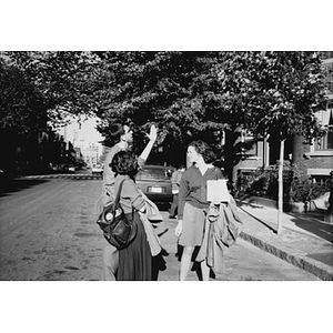 Three people in front of Residencia Betances during the ceremony to mark the opening of the new housing units.