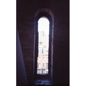 View out the narrow, arched window of the former Shawmut Congregational Church.