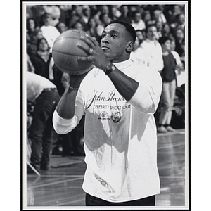 Former NFL player Irving Fryar shooting a basketball at a fund-raising event held by the Boys and Girls Clubs of Boston and Boston Celtics