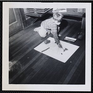 A boy working on a painting for his art class at the Charlestown Boys' Club