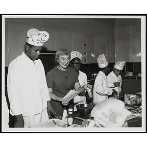 Members of the Tom Pappas Chefs' Club and an unidentified woman participate in a cooking demonstration in Roxbury, Massachusetts
