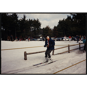 A girl on skis holds onto a tow rope at a resort