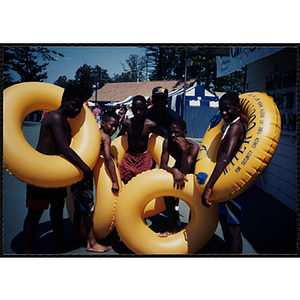 Children hold intertubes at Water Country water park during a Tri-Club field trip