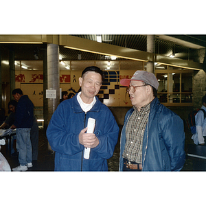 Two men talking at a voter rights event