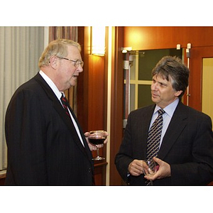 Neal Finnegan (CBA '61), left, and Dean of Northeastern College of Business Administration Dr. Ira R. Weiss, right, talking at the College of Business Administration's Distinguished Service Awards ceremony