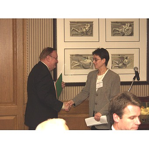 Iulia Lazar shaking hands with Barry Karger at the gala dinner in honor of John Hatsopoulos