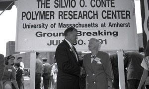 Ceremonial groundbreaking: unidentified official shaking hands with Corinne Conte