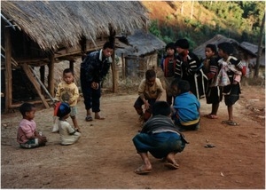 Young boys playing game in rural village, Southern Thailand