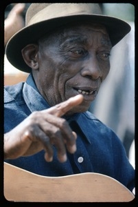 Mississippi John Hurt: in concert, playing guitar (at Newport?)