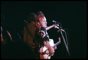 Stephen Stills (Crosby, Stills, and Nash) performing on stage at the Woodstock Festival