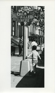 Child playing on sidewalk
