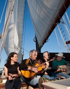 Pete Seeger playing music aboard the Mystic Whalter with Raffi, David Ameram, and Lucy Kaplansky (from right) during the Clearwater Festival