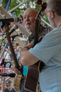 Pete Seeger performing on stage at the Clearwater Festival