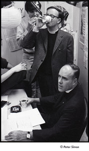 Malcolm Boyd at Boston University: Boyd (seated) in the BU News room with (l-r) Raymond Mungo (just out of frame), Joe Pilati, an unidentified woman, and an unidentified man