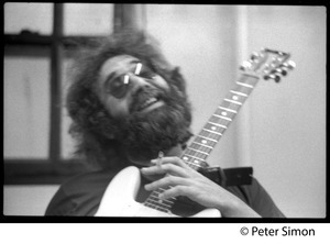 Jerry Garcia: portrait with guitar and cigarette