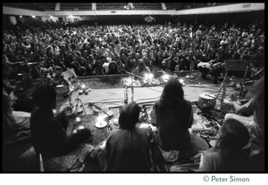 View from the stage of massive audience in the Winterland Ballroom during the Ram Dass 'marathon,' looking over the band Amazing Grace