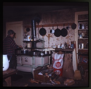 Nina Keller's mother cooking at the stove, Montague Farm Commune