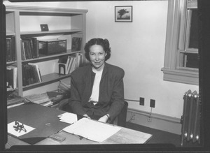 Helen Cole Curtis sitting indoors, behind desk