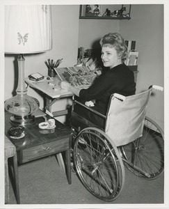 Mrs. Frances Marsala seated in her wheelchair doing artwork