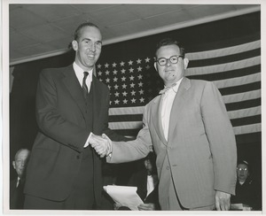 Unidentified men shaking hands at Institute Day