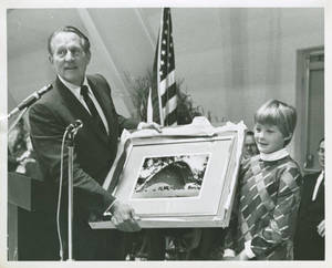 Kathleen Camuse Presents Art Linkletter with a Photograph of Linkletter Natatorium, 1967