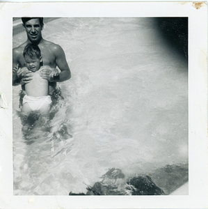 Bob Mello, in pool with baby
