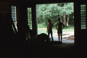 Peter McChesney (on right) inspects barn beams in Hopkins Forest Carriage Barn before 2 August 1975 Moon Barn raising.