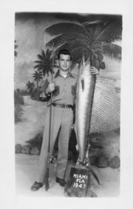 John Joseph Moakley posing with a sailfish and fishing pole in Miami, Florida, 1947