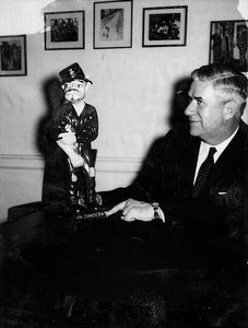 Informal pose of Thomas P. O'Neill with figurine of Irishman, labelled "I'm Dimocrat."