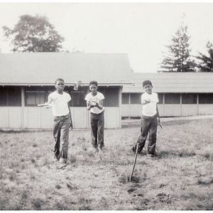 Three boys play horseshoes at Breezy Meadows Camp