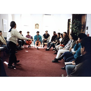 Unidentified woman facilitating a community meeting in the Inquilinos Boricuas en Acción offices.