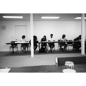Inquilinos Boricuas en Acción staff members sitting at desks, writing, or perhaps taking a test.
