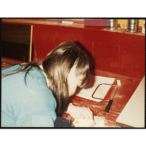 A girl working on a project for her woodworking class at the Boys & Girls Club