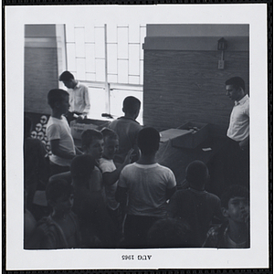 Boys wait to play an indoor game at a carnival