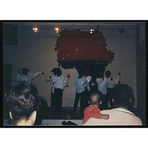 Girls perform on a stage at a Black History celebration