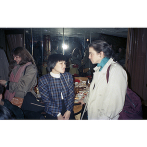 Two women at a restaurant during the Chinese Progressive Association's celebration of the Lunar New Year