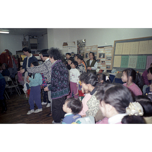 Adults and children attend a Chinese Progressive Association holiday party