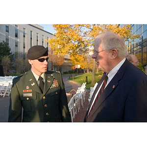 Neal Finnegan converses with a man in military uniform at the Veterans Memorial dedication ceremony