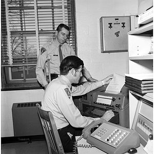 A Criminal Justice student works with the dispatcher at the Lexington Police Department during co-op