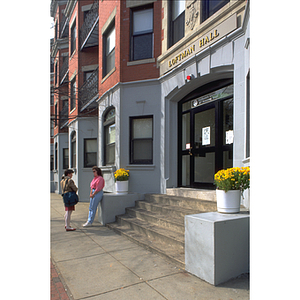 Two female students conversing outside of the Loftman Hall dormitory