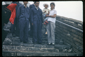 Group standing atop the mist-shrouded Great Wall