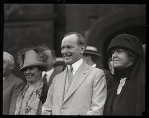 Calvin Coolidge, standing between wife Grace (left) and unidentified woman